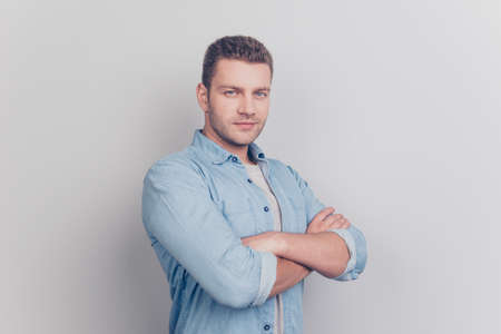 Photo of half turned man look at camera hold hands over chest st