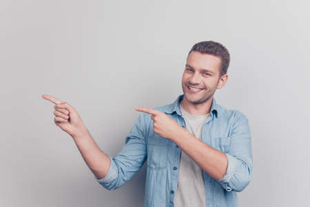 Photo of handsome attractive man look at camera demonstrate fingの写真素材