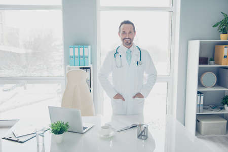 Handsome attractive stubble brunet hair assistant stand near tabの写真素材