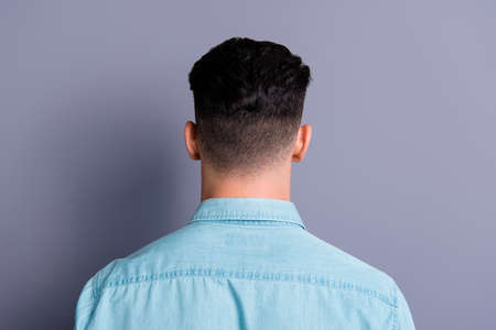 Rear back view of attractive handsome man wearing blue formal sh