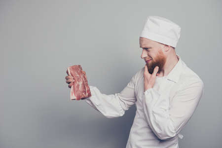Profile side view portrait of nice handsome minded butcher guy hの写真素材