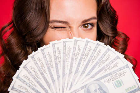 Close-up cropped portrait of rich funky attractive cheerful positive wavy-haired lady holding in...