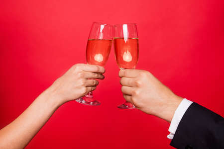 Cropped close-up view of two hands holding glasses new year xmas
