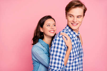 Young women hug her boyfriend from behind