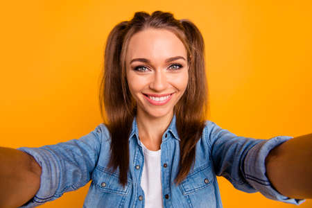 Young attractive girl hold the camera and smiling