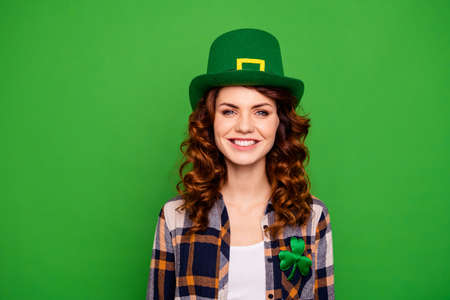close up image of a lady with st. patrick's paper hat. green backgroundの写真素材