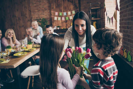 Close up photo of gathered relatives at homeの写真素材