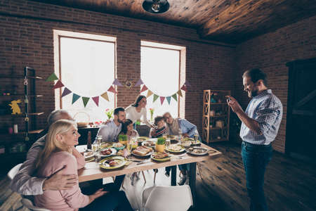 Close up photo of gathered relatives at homeの写真素材