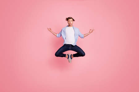 Full length body size photo of jumping high crazy he his him handsome holding hands arms fingers lotus shape figure wearing casual jeans checkered plaid shirt isolated on rose backgroundの写真素材
