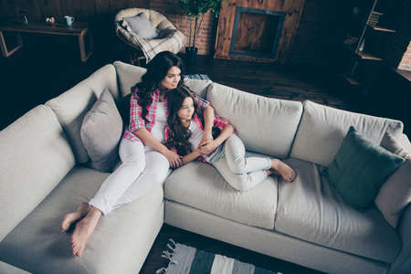 High angle view portrait of nice gorgeous cute lovely sweet attractive charming cheerful cheery wavy-haired people cuddling sitting on divan weekend in house indoorsの写真素材