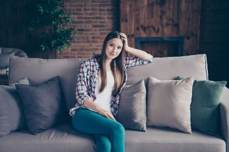 Pretty sweet peaceful charming attractive tranquil nice glad optimistic she her lady having rest on classic beige divan looking at cameraの写真素材
