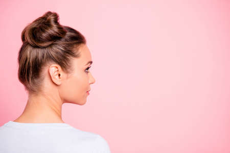Close-up profile side view of nice cute attractive groomed candid girl wearing two fashionable buns copy empty blank space place isolated over pink pastel backgroundの写真素材