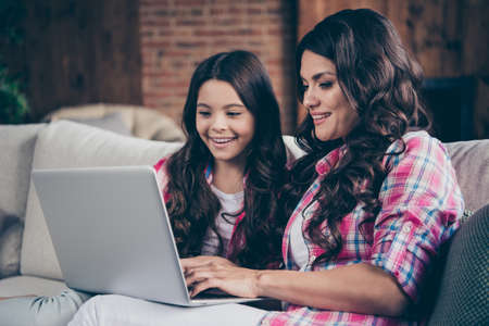 Close-up portrait of nice cute lovely winsome attractive charming cheerful cheery dreamy positive wavy-haired people enjoying typing letter email in house indoorsの写真素材