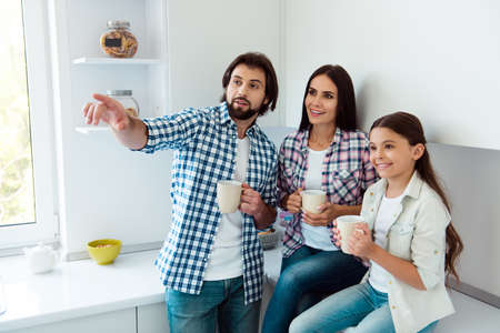 Portrait of nice cute sweet lovely attractive cheerful cheery people sitting on countertop...
