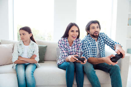 Portrait of nice cute lovely attractive cheerful positive funny people mom dad attending contest winning sad girl lose sitting on divan in light white modern interior indoorsの写真素材