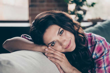 Close-up portrait of nice lovely cute gorgeous adorable winsome attractive charming cheerful cheery dreamy wavy-haired lady enjoying free time in house indoorsの写真素材