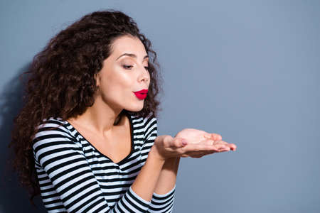 Close-up portrait of her she nice cute glamorous attractive winsome lovely lovable cheerful wavy-haired lady blowing kiss isolated over gray pastel backgroundの写真素材