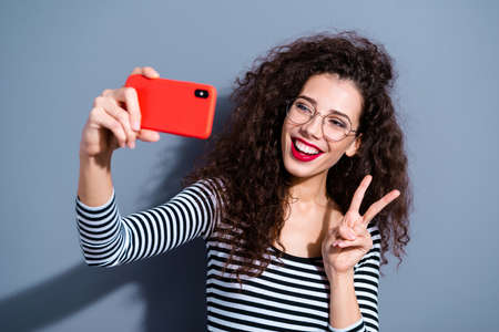 Closeup photo portrait of cheerful excited lovely carefree with teeth toothy beaming smile make take selfie on bright camera device gadget isolated grey backgroundの写真素材