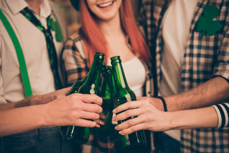Cropped close up photo gathering company together tell speak talk toast tradition culture carefree guys best friends ever weekend vacation hands raise beer bottles glad meeting ginger red hairの写真素材