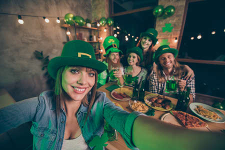 Self-portrait of nice cute attractive lovely sweet charming lady cheerful cheery positive group of people guys gathering meeting having fun congratulations festive indoors pub Marchの写真素材