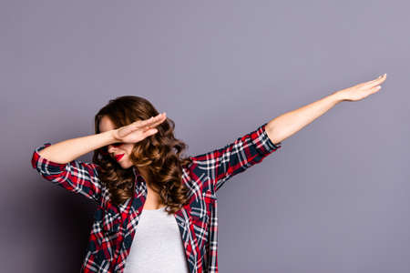 Close up portrait of an amazing  lady, hands up, on her  red dark bright summer glasses, wearing casual checkered shirt isolated on grey backgroundの写真素材