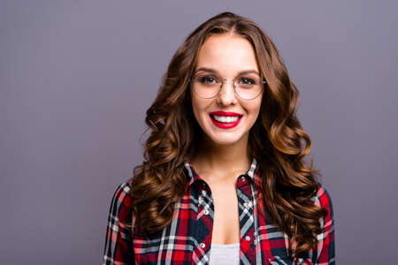 Close up portrait of amazing beautiful she her lady people person sweet awesome hairdo cosmetics toothy beaming smiling wearing specs checkered plaid shirt clothes isolated grey backgroundの写真素材