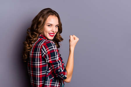 Profile side view portrait of her she nice cute attractive lovely magnificent well-groomed charming pretty cheerful wavy-haired lady showing winning gesture isolated over gray pastel backgroundの写真素材