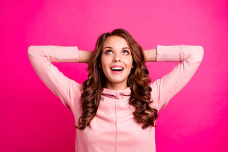 Close up photo amazing beautiful she her lady eyes look up to empty space imagination mood hands arms behind head wearing modern casual pink pullover outfit isolated vibrant vivid rose backgroundの写真素材