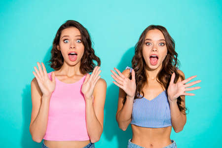 Close up portrait two amazing beautiful yelling she her lady meeting gathering unexpected news open mouth really cool wearing colored shiny shorts tank tops isolated teal bright vivid backgroundの写真素材