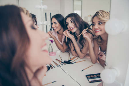 Portrait of nice cute fascinating attractive lovely well-groomed glamorous shine cheerful girlfriends having fun domestic skin care in light white interior decorated house indoorsの写真素材