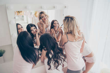 Above high angle view of nice fascinating attractive lovely well-groomed glamorous shine cheerful girlfriends domestic skin care skincare in light white interior decorated house indoorsの写真素材