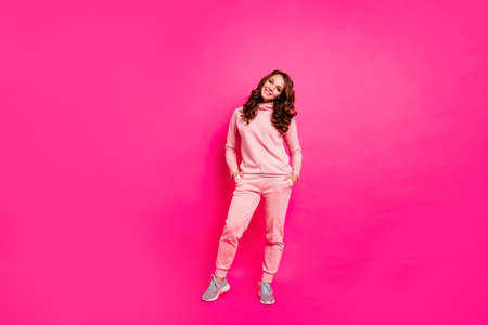 Full length body size photo toothy beaming smiling amazing she her lady hands arms in pockets self-confident wearing modern casual pink costume suit pullover outfit isolated vibrant rose backgroundの写真素材