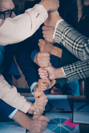Vertical view of stylish elegant experts executive staff director top management putting fists on each other gathering result goal achievement corporate human recruitment at work place stationの写真素材