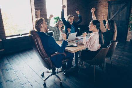 Nice elegant clever smart intelligent attractive cheerful executive top management company appointment celebrating good financial result profit at modern industrial loft interior work place stationの写真素材