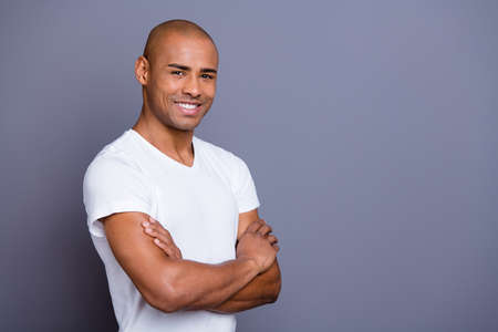 Close up photo strong healthy masculine dark skin he him his macho bald head arms crossed satisfied after first date want one more wearing white t-shirt outfit clothes isolated grey background.の写真素材