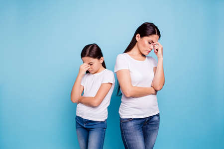 Close up photo two people brown haired mum disinterested small little daughter hand on face sick and...