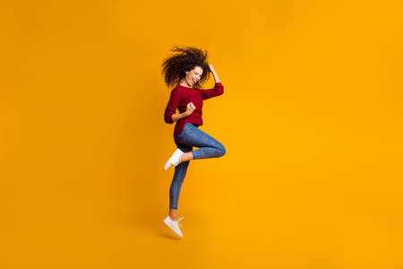 Full length body size view of her she nice lovely sporty attractive cheerful cheery ecstatic slim fit adorable wavy-haired lady satisfaction success isolated on bright vivid shine orange backgroundの写真素材