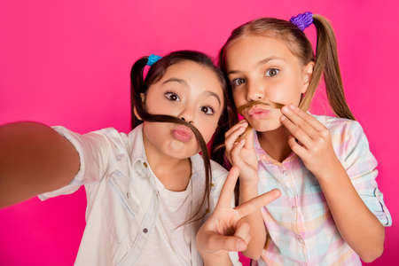 Close up photo two small little age she her girls moustache pretend make take summer camp selfies...
