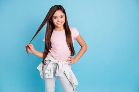 Portrait of her she nice cute lovely trendy pretty attractive cheerful straight-haired brunette girl demonstrating long shine groomed hair curls isolated over blue pastel backgroundの写真素材