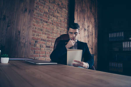 Portrait of nice handsome stylish intelligent guy reading notes plan diary daily to-do list creating...