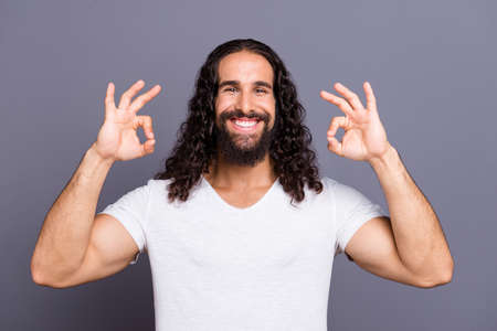 Portrait of cool groomed attractive cheerful cheery optimistic glad wavy-haired guy showing two ok-sign isolated over gray violet purple pastel background.の写真素材