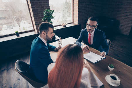 Above high angle view portrait of three stylish handsome serious busy executive top sales managers...