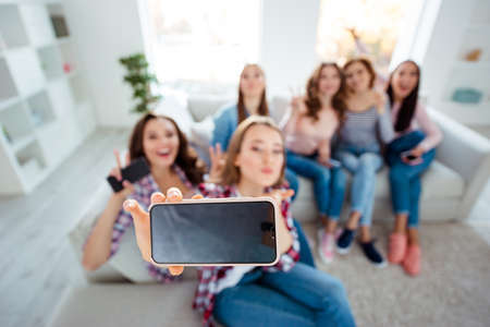 Above hign angle view of nice charming attractive cheerful cheery ladies taking making selfie showing v-sign in light white interior room indoorsの写真素材