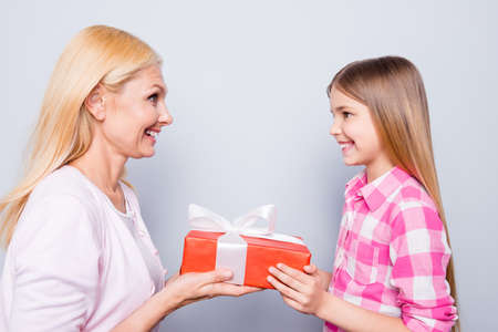 Close up side profile photo blond hair she her granny little granddaughter hold large big giftbox...