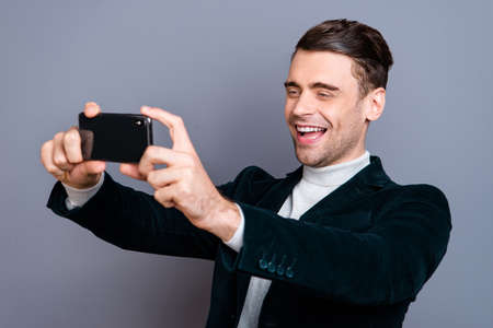 Portrait of his he nice attractive handsome bearded cheerful cheery positive guy wearing velveteen blazer making taking selfie day isolated over gray blue pastel backgroundの写真素材