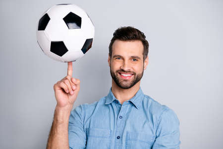 Close up photo amazing macho he him his guy show hand arm finger hold football leather ball round moves show cool tricks wear casual jeans denim shirts outfit clothes isolated light grey backgroundの写真素材