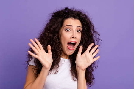 Close up photo funky yelling loud beautiful her she lady hold arms hands up air asking begging not do that eyes full fear wear casual white t-shirt clothes outfit isolated violet purple backgroundの写真素材