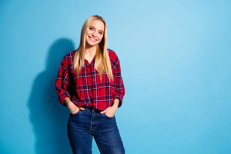 Portrait of charming pretty lady have fun feel glad rejoice place hands palms in pockets dressed in plaid modern outfit isolated on pastel backgroundの写真素材