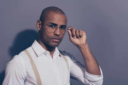 Close up side profile photo beautiful amazing dark skin he him his macho hand arm hold specs employer collar financier shaved face wear pastel suspenders white shirt isolated grey backgroundの写真素材