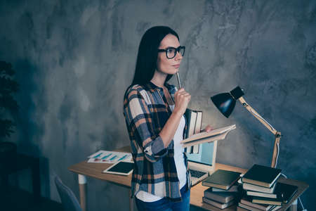 Profile side view of nice cute attractive charming minded brunette lady checked shirt creating...